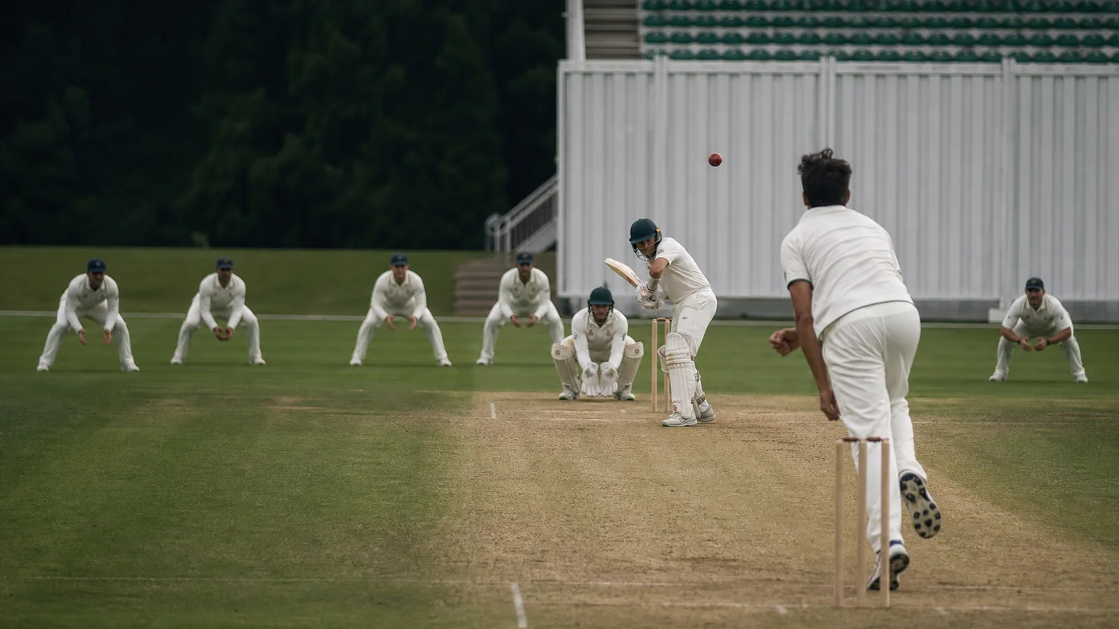 A fictional Test fast bowler delivers with a wicketkeeper, four slips and gully waiting behind the batter