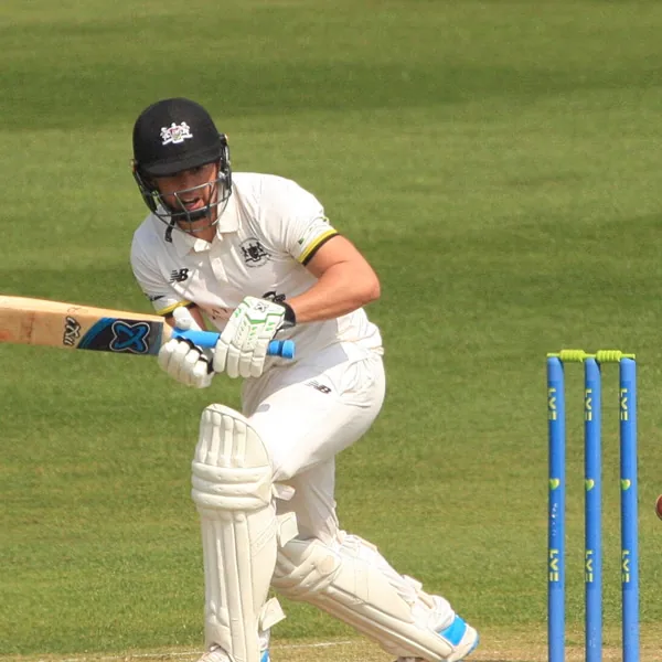 Graeme van Buuren portrait in Gloucestershire County Championship playing shirt and helmet