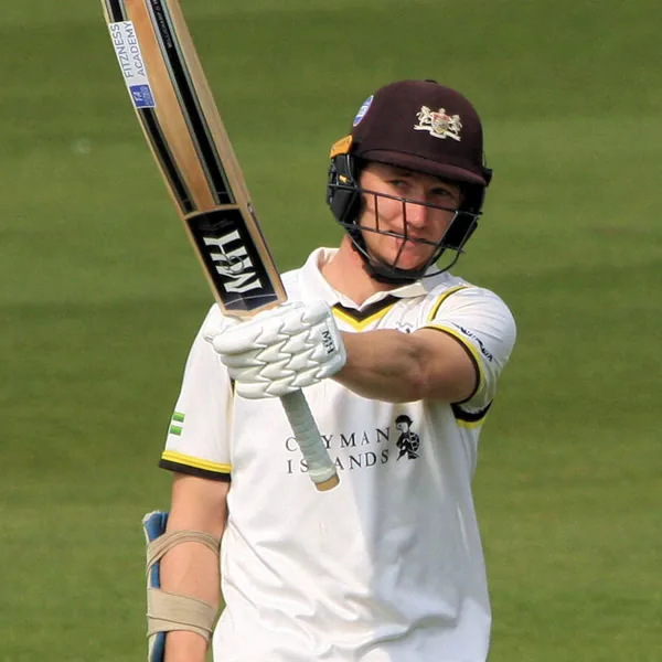 James Bracey portrait in Gloucestershire County Championship playing shirt and helmet