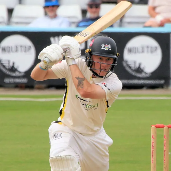 Miles Hammond portrait in Gloucestershire County Championship playing shirt and helmet